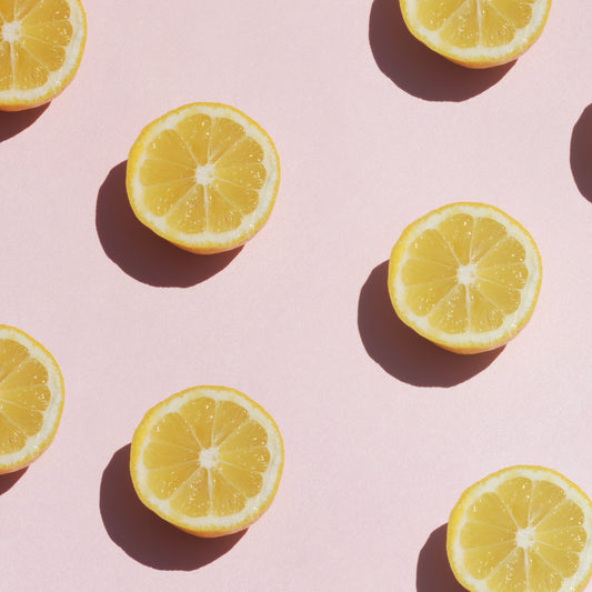 lemons cut in half and displayed in a formation to create a bold fruity pattern